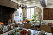 Open fireplace and stone walls in traditional dining room