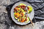 A salad of avocado, blood orange, roasted chickpeas, pistachios and cress