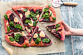 Homemade beetroot pizza with spinach, goa'st cheese, sour cream, honey and thyme