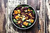 A superfood salad with avocado, beetroot, roasted chickpeas, sweet potato, beluga lentils and spinach