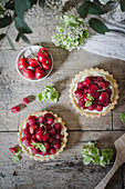 Cherry and raspberry tarts on a wooden rustic table