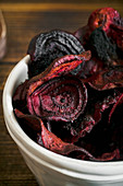 Organic homemade beetroot chips cooked in oven with olive oil, pepper and salt
