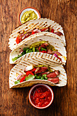 Grilled Beef steak Fajitas taco tortillas with salsa and bell pepper