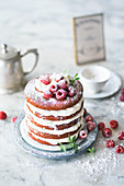 A red velvet cake with vanilla cream and raspberries