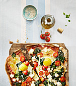 Spinach pizza with egg and feta cheese