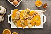 Crepes suzette with cream cheese filling, orange sauce and fresh oranges
