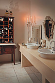 Long washstand next to antique bureau used as shoe cabinet