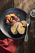 Stuffed grilled meatloaf on a potato and beetroot salad