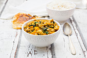 Vegetable curry with cauliflower, butternut squash, spinach and coriander served with poppadoms and rice
