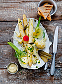 An antipasti platter with asparagus, mayonnaise and toast