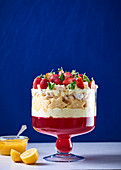 Trifle with strawberry jelly, biscuit stars, strawberries and lemon curd