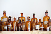 Apothecary bottles on wooden shelf