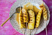 Grilled pineapple kebab with caramel sauce