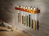 Storage idea for spices in test tubes in wall-mounted rack