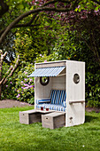 DIY wooden beach chair with blue-striped cushions