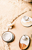 Plates and cups with speckled and trimmed glaze on sand