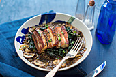 Pork belly on lentils with mushrooms and cabbage