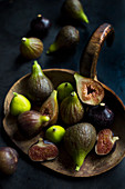 Three types of organic figs on an old wooden board
