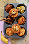 Cinnamon and banana muffins in a muffin tin