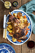 Roast lamb on a bed of vegetables