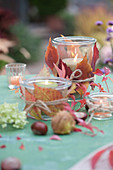 Mason Jars With Autumn Leaves Decorated As Lanterns