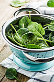 Baby spinach in strainer