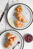 Croissants with butter and strawberry jam