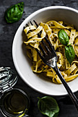Fettuccine pasta with lemon and basil sauce. Sprinkle with parmesan and black pepper