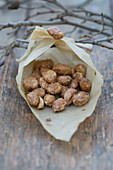 Homemade roasted almonds in a paper bag