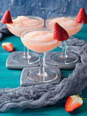 Slushy cocktail drink with frozen rosè wine, strawberry sugar syrup and lemon juice (Frosè)
