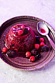 A summer pudding served with raspberries, blackberries and blackcurrants