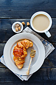 A croissant with milky coffee (top view)