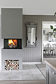 Fire in modern fireplace in grey interior