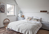 Double bed in white bedroom