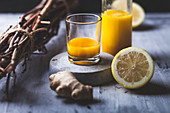 Detox and ginger shots with ginger juice, orange juice, lemon juice, turmeric and chilli