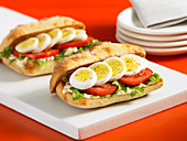 Sandwiches with rocket, tomatoes and hard-boiled eggs (Italy)