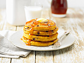 Pumpkin pancakes with chocolate drops and maple syrup