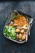 Chicken escalope with a cornflake coating, polenta potatoes and salad in a baking tin