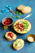 Bean hummus with broad beans, pomegranate seeds and sesame seeds
