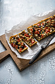 A vegan potato quiche with tomatoes, aubergines and courgette