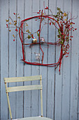 A DIY 'window' made from red dogwood twigs, rose hips and hawthorn berries