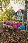 A festively laid table in an autumnal garden