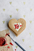 White chocolate centered heart biscuits with freeze dried strawberries and glitter to decorate
