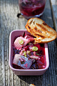 Pickled herring with beetroot and spring onions