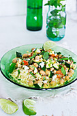 Couscous salad with chickpeas, grilled vegetables, limes, peppermint and feta cheese
