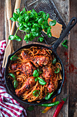 Pasta with chicken legs, hot pepper and tomato sauce