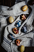 Naturally dyed eggs decorated with flowers on a linen cloth