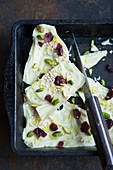 White chocolate with amaranth, cranberries, pistachio nuts and edible flowers