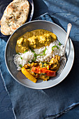 Chicken jalfrezi and chicken korma with rice and naan bread (India)