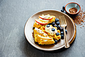 Belgian waffles with cream, fresh fruit and flaxseeds